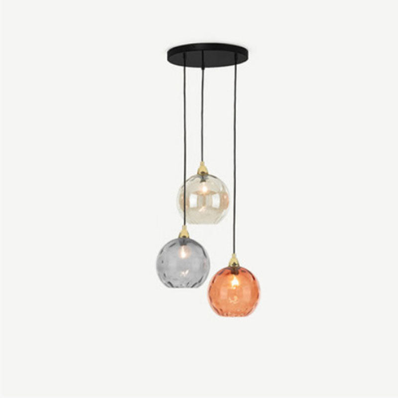 Gray colourway of the Clérachic 3-globe cluster pendant, amber, smoke and orange ripple glass on staggered black cords.