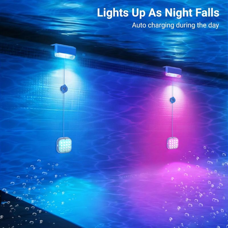 Clérachic pool lights glowing under water at night, pods lit blue and pink below the surface.