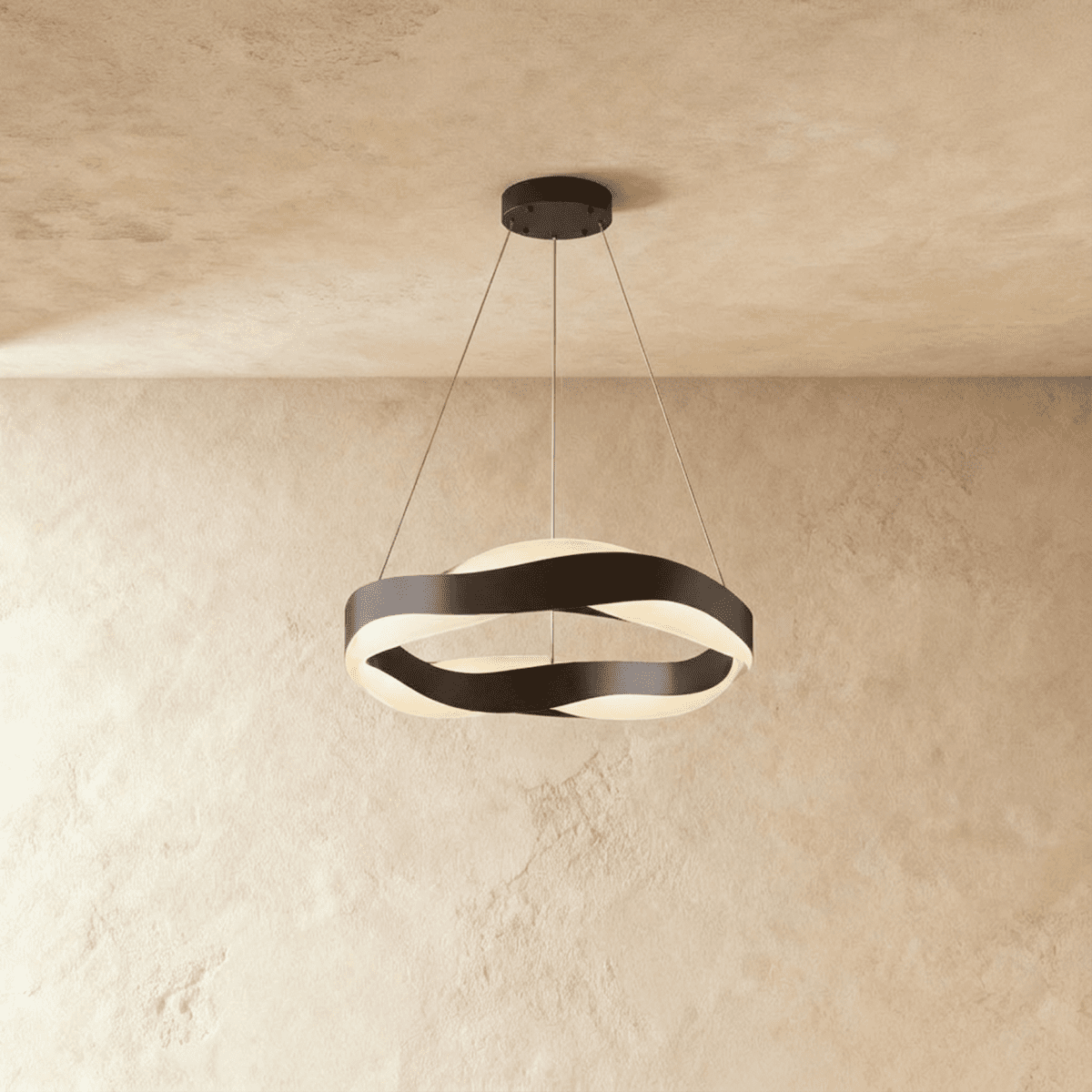 Clérachic round wave chandelier with black twisting bands and a black ceiling plate, lit on a warm plaster wall.