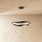 Clérachic larger round chandelier with black wavy bands and soft frosted light, hung on thin cables.