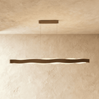 Clérachic longest linear wave pendant in a bronze-toned finish, two cables and an oblong canopy on a plaster wall.