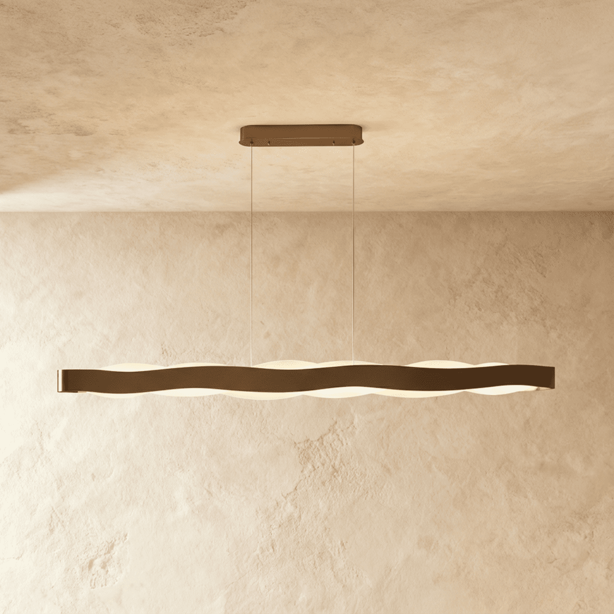 Clérachic longest linear wave pendant in a bronze-toned finish, two cables and an oblong canopy on a plaster wall.