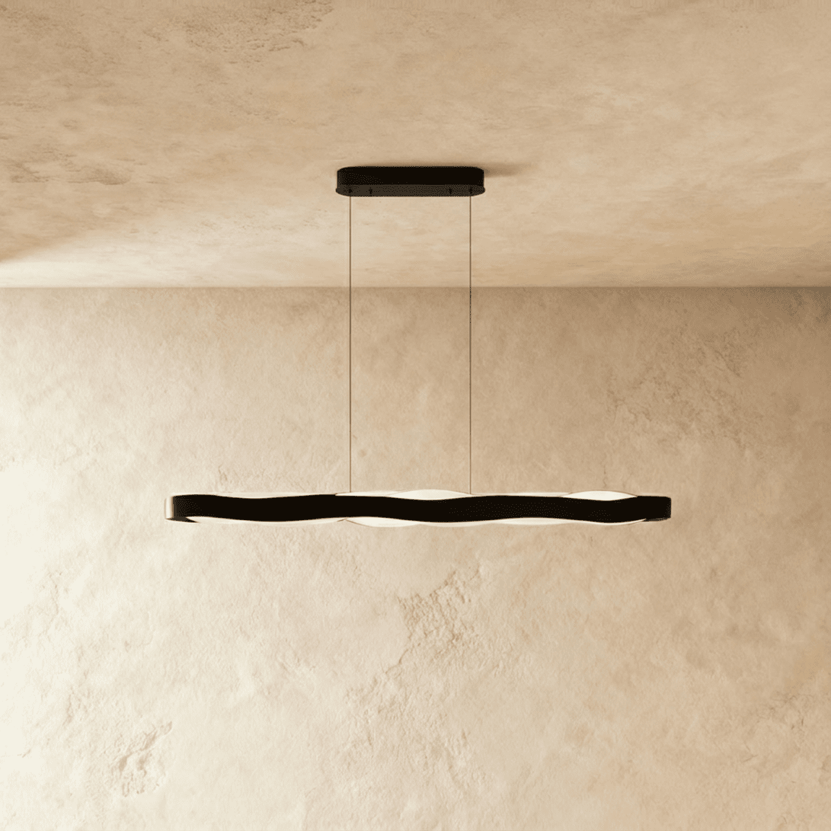 Clérachic black linear wave pendant on two thin cables, its soft frosted LED glow visible below the band.