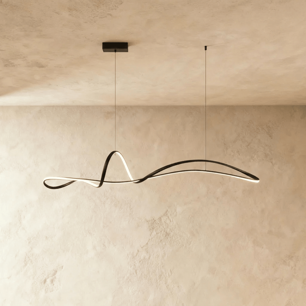 Clérachic black sculptural ribbon pendant with a glowing LED edge, hung from a small rectangular canopy against plaster.