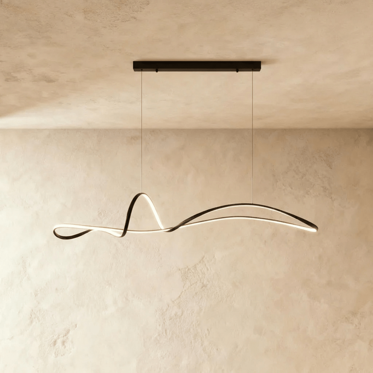 Clérachic black wave-like ribbon pendant with a warm LED edge, suspended from a long black horizontal bar canopy.