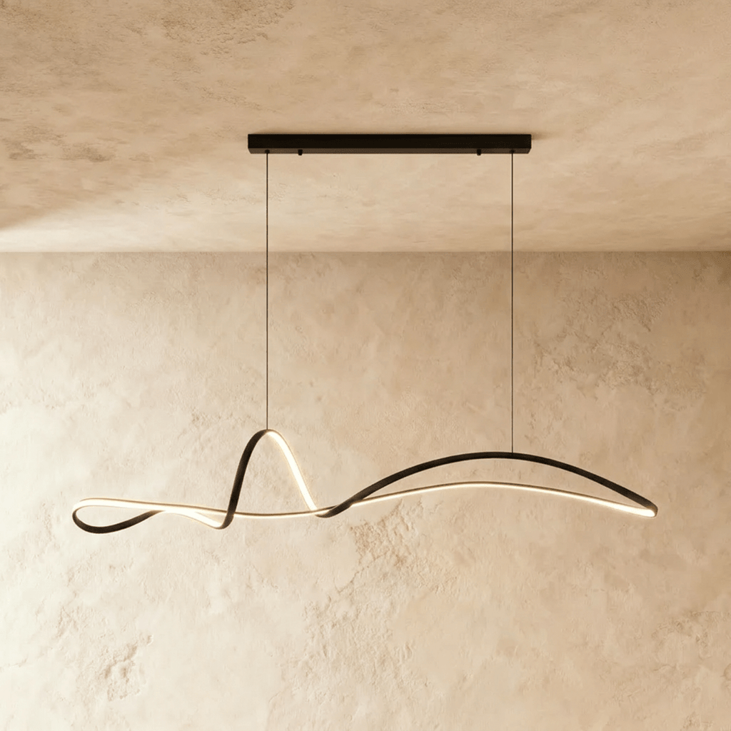 Clérachic longer black ribbon pendant glowing along its curve, hung from a horizontal bar canopy against a plaster wall.