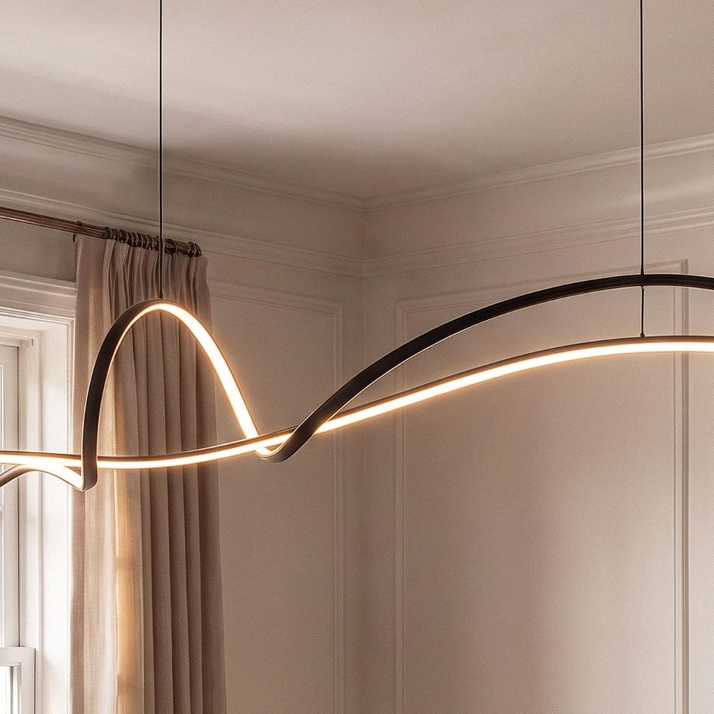 Close view of the Clérachic black ribbon pendant curving and twisting, its slim LED edge lit against panelled walls.
