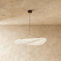 Clérachic white fabric-like pendant with a twisted, leaf-shaped shade on two thin wires, hung from a black ceiling rose.