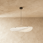 Clérachic white fabric-like pendant with a twisted, leaf-shaped shade on two thin wires, hung from a black ceiling rose.