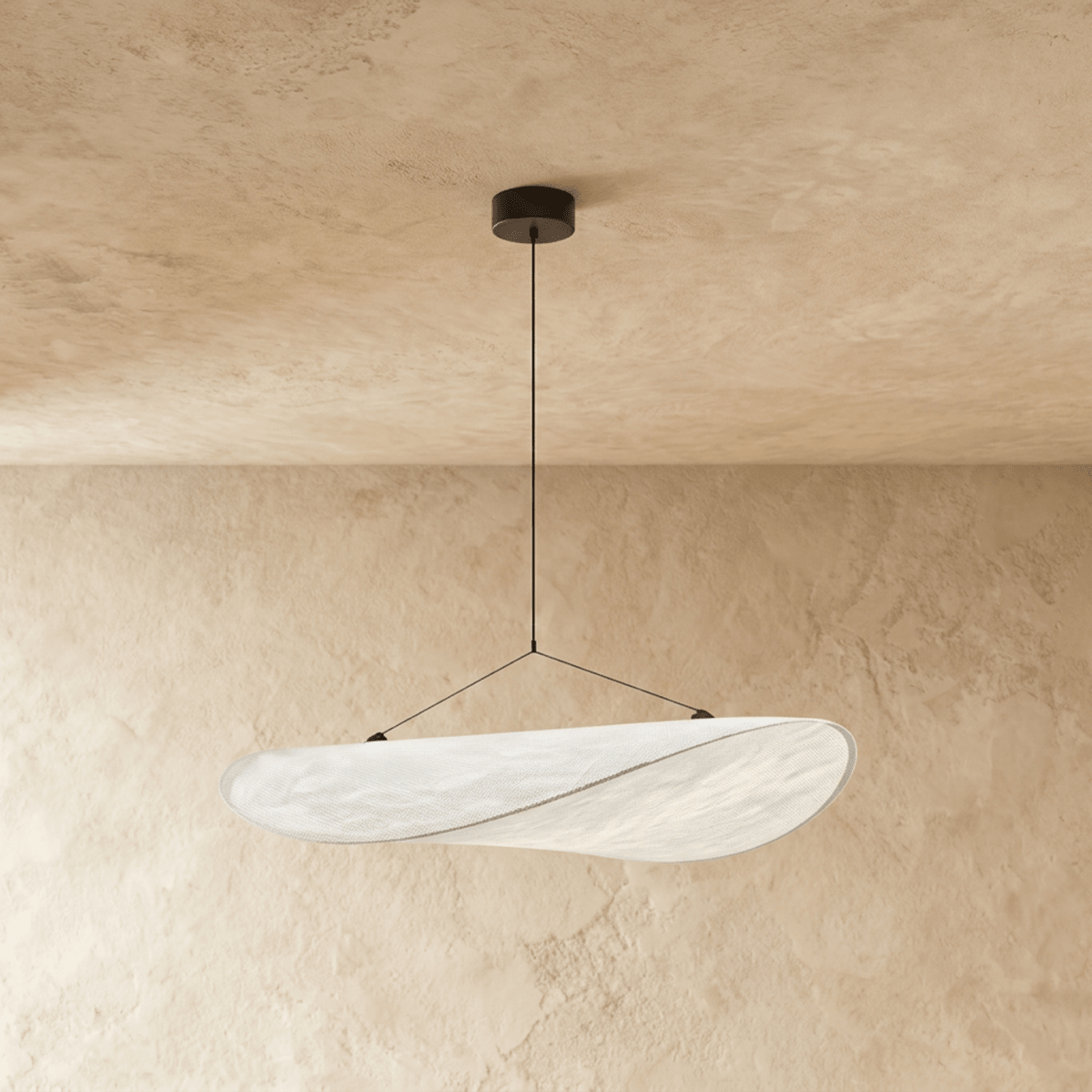 Clérachic white leaf-shaped pendant with a slim edge seam, suspended on two wires beneath a textured plaster ceiling.