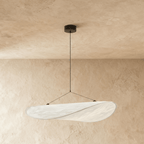 Clérachic white pendant with a soft rolled edge and a visible weave, hanging beneath a black ceiling rose on plaster.