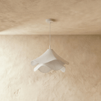Clérachic unlit white fabric pendant with two rippling layers on a white canopy and stem, in front of limewash.