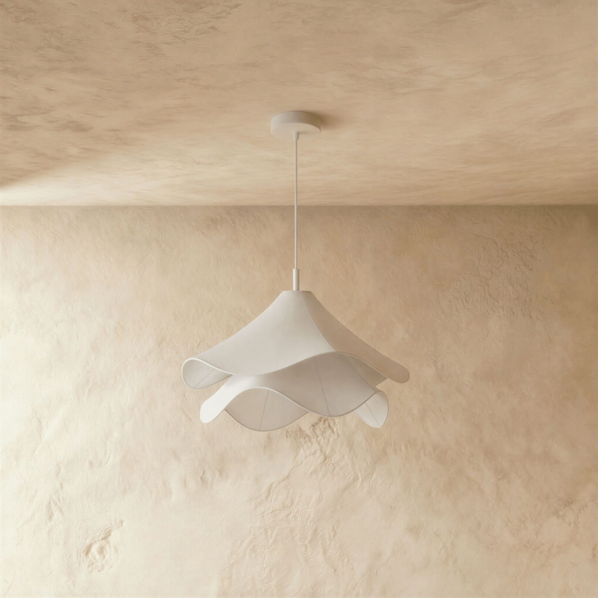 Clérachic unlit white fabric pendant with two rippling layers on a white canopy and stem, in front of limewash.
