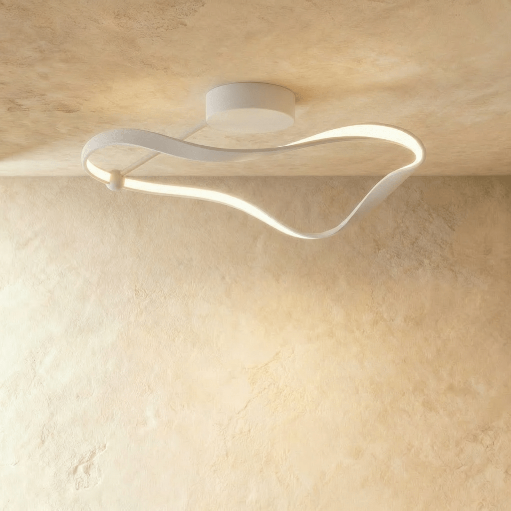 Clérachic mid-length white ribbon ceiling light with a soft diffused LED band and a round canopy, on a warm plaster ceiling.