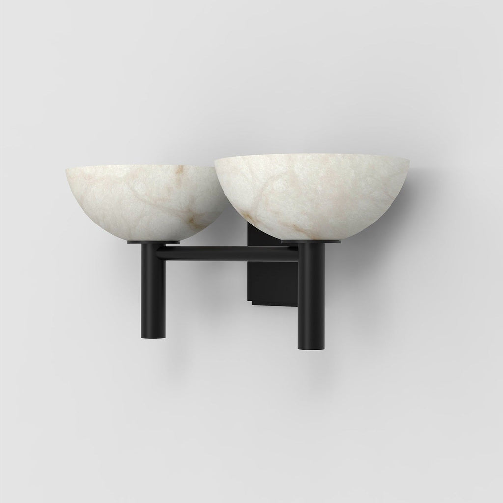 The Clérachic Weft sconce in black, three-quarter view showing the two upright posts under each alabaster bowl.
