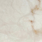 Close detail of the alabaster used on the Clérachic Weft sconce, warm russet veining running through pale stone.