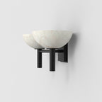 Clérachic Weft sconce in black seen from the side, the wall plate and arms reading as one continuous line.