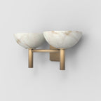 The Clérachic Weft sconce in brass from the left, showing the drop of the two posts below the alabaster bowls.