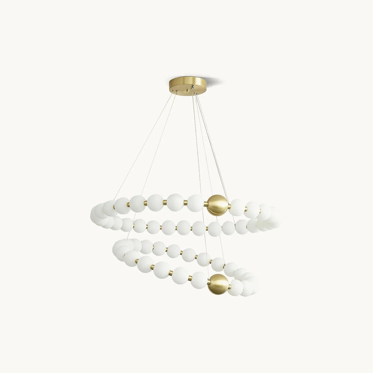 A Clérachic chandelier with two spiralling rings of white globes joined by brass spheres, on a plain off-white backdrop.