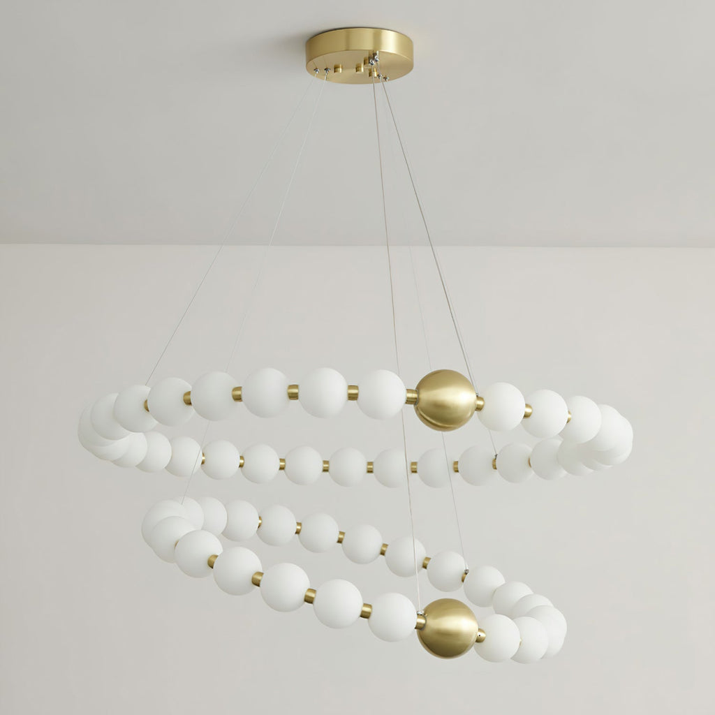 The same Clérachic chandelier unlit, showing its white globes in two spiralling rings under a brass ceiling plate.