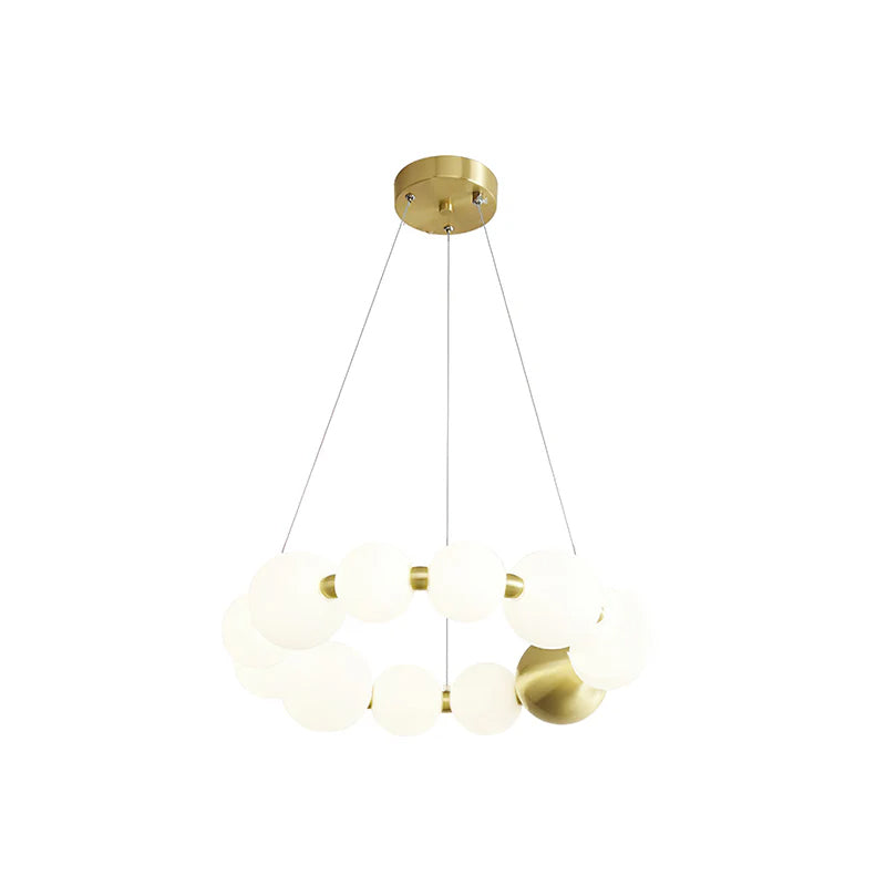 A smaller Clérachic chandelier of white globes arranged in a double ring, on a plain white backdrop.