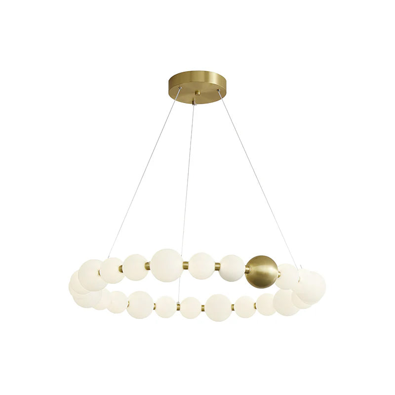 A wide single-ring Clérachic chandelier of white globes with one brass sphere, on a plain white backdrop.