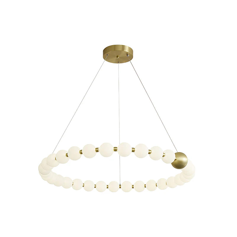 A single ring of white globes on this Clérachic chandelier, with one brass sphere and a round brass canopy, on white.
