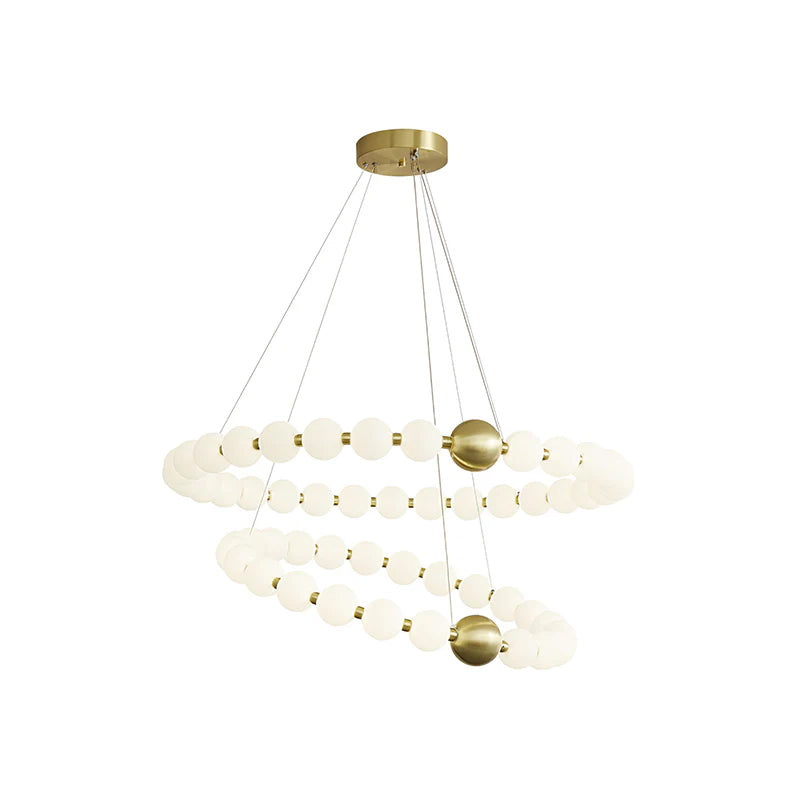 A Clérachic chandelier with two stacked spiral rings of white globes and two brass spheres, hung low on a white background.