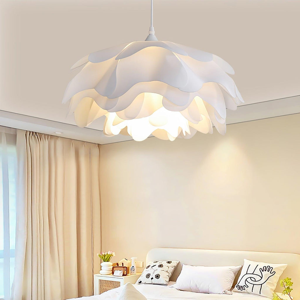 Over a bedroom with cream bedding and beige curtains, this Clérachic pendant shows its white petal layers lit from below.