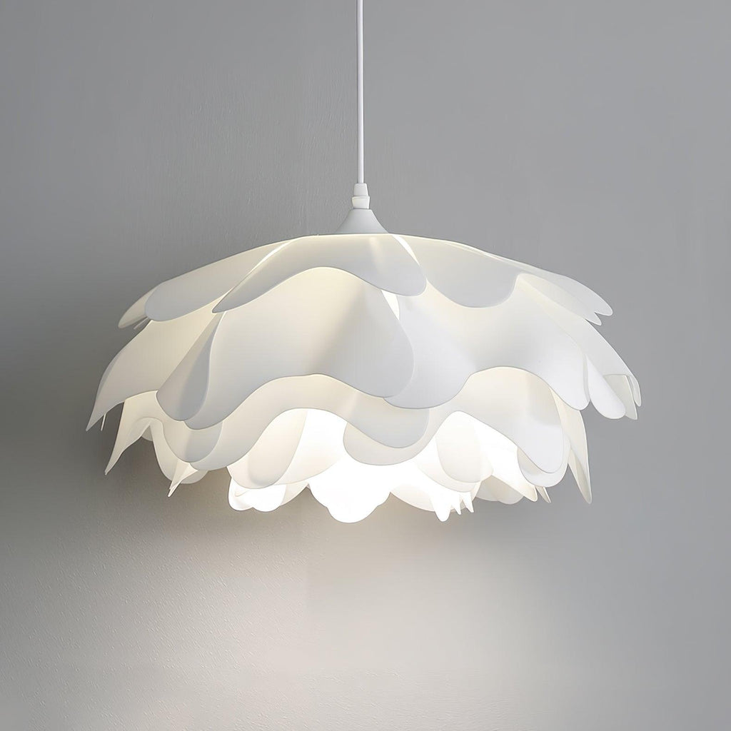 Close, lit view of the scalloped petal edges on this Clérachic pendant against a soft grey wall.