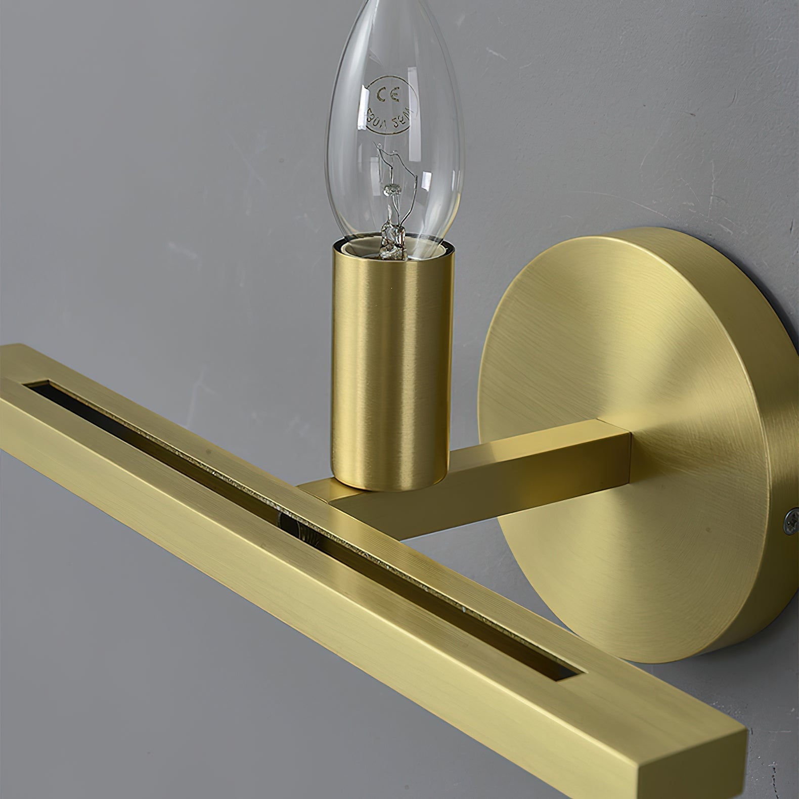 Clérachic White Alabaster Wall Sconce with the shade off, showing the candle bulb seated in its brushed brass socket.