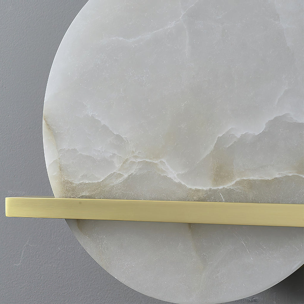Close crop of the Clérachic White Alabaster Wall Sconce showing the unlit stone's cloudy veining behind the flat brass bar.