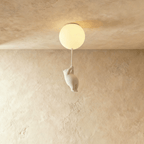 Clérachic white ceramic bear figurine climbs a cord beneath a frosted glass globe flush-mounted to a plaster ceiling.