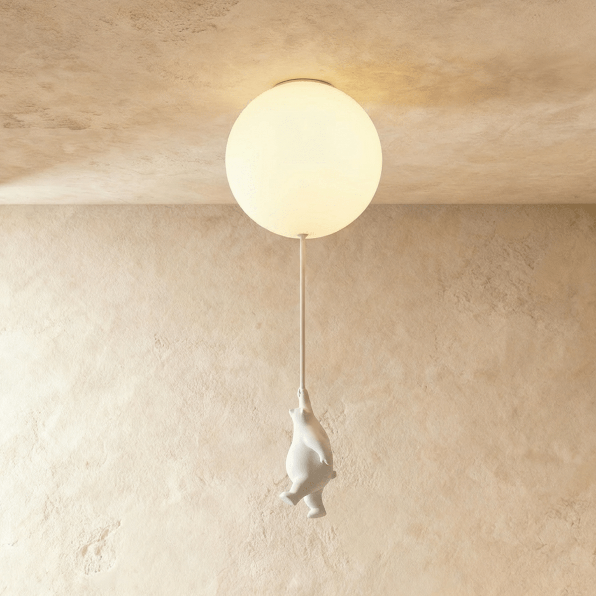Clérachic ceramic bear reaches upward on its cord, suspended just under a glowing frosted glass ceiling globe.