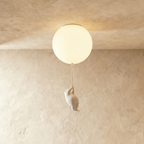 Clérachic ceramic bear climbs toward a glowing frosted glass globe mounted flush to a textured plaster ceiling.