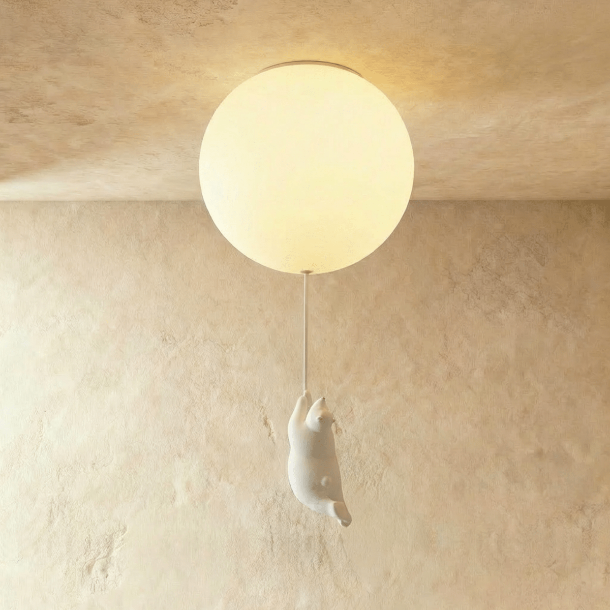 Clérachic single frosted glass globe ceiling light with a bear figurine mid-climb, set on a warm plaster wall.