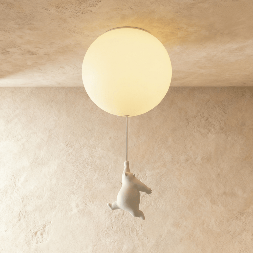 Clérachic ceramic bear figurine mid-climb below a single warm-lit frosted glass globe on a plaster ceiling.