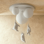 Clérachic multi-globe ceiling light shows three bear figurines hanging from cords beneath frosted glass spheres.