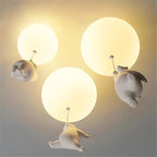 Clérachic bear balloon ceiling lights grouped in three sizes, warm globes glowing above climbing figurines.