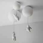 Clérachic bear balloon lights compared in three sizes, white figurines climbing cords below glowing globes.