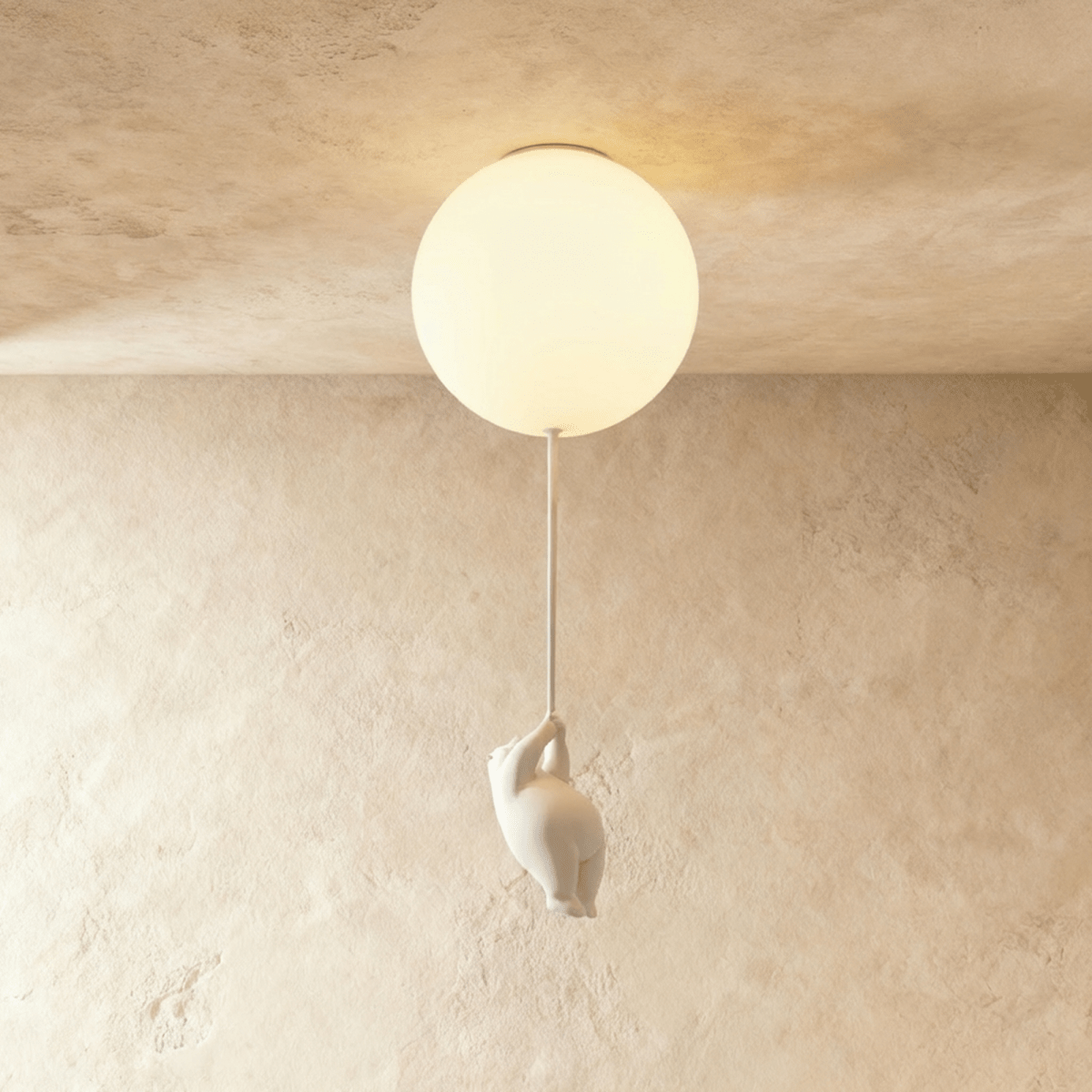 Clérachic single frosted glass globe ceiling light glows warm, a bear figurine climbing the cord beneath it.