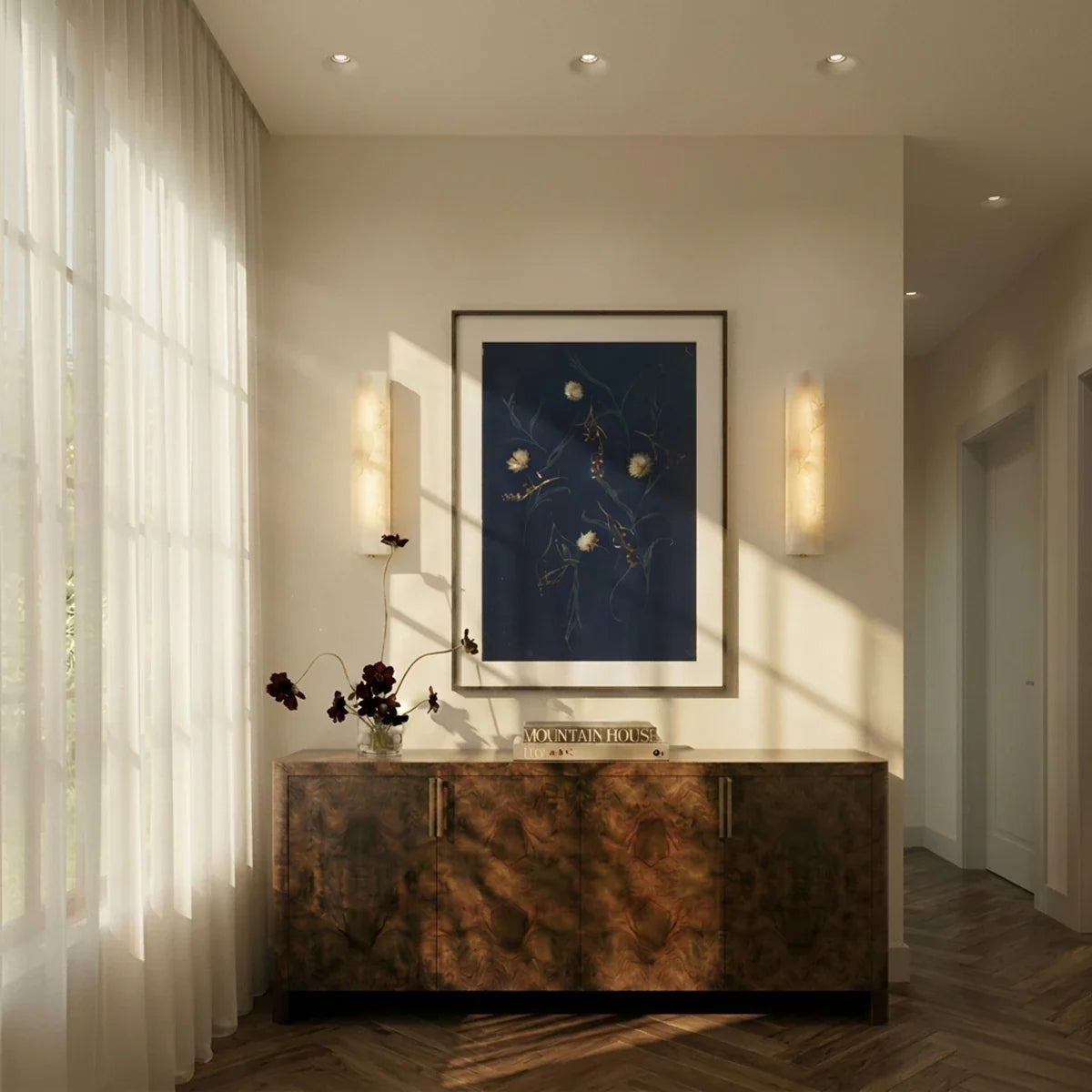 Clérachic trimless recessed downlights lining a hallway ceiling above a burl-wood console and wall sconces.
