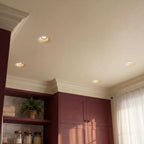 Clérachic trimless recessed downlights set flush into a pantry ceiling above burgundy cabinetry and crown molding.