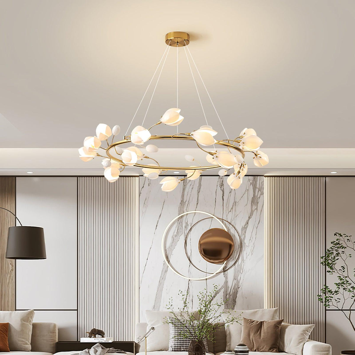 Lit Clérachic petal chandelier with a gold ring above a living room with a marble feature wall, fluted panels and a bronze mirror.
