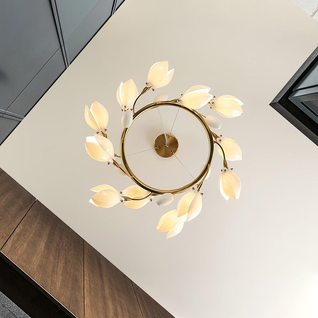 Looking up at the Clérachic ring chandelier from below, with white petal shades circling a gold ring and its round canopy.