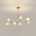 A Clérachic chandelier on a gold rod, with a flat curved arm of white petals, lit against a beige wall with a soft light glow above it.