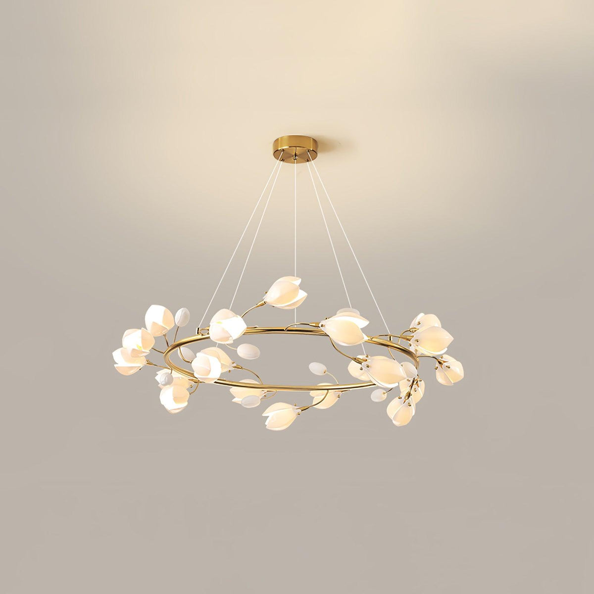 Wide Clérachic ring chandelier in gold, with the white petals spaced around the ring and fine cables rising to the canopy.