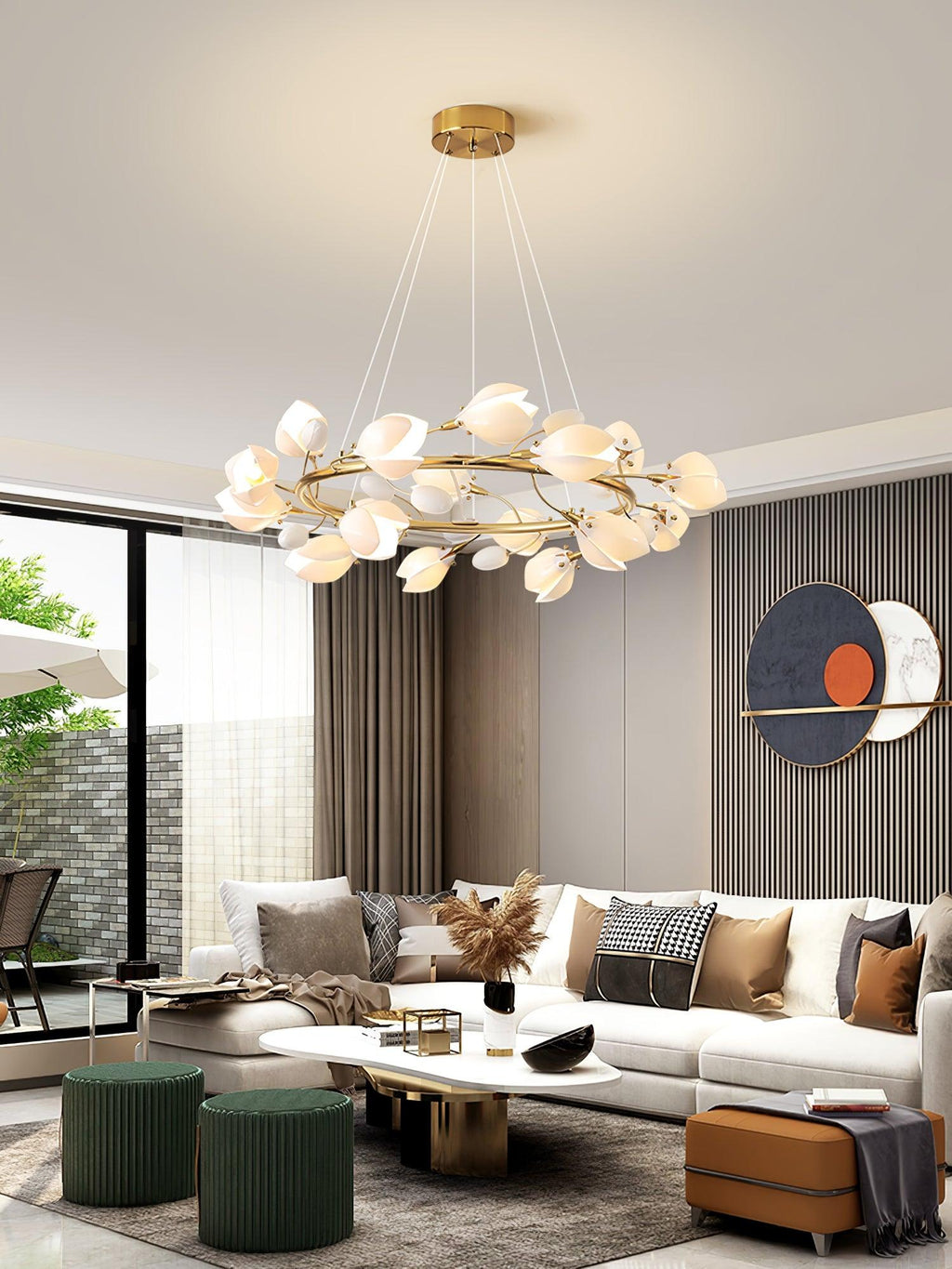 A Clérachic ring chandelier of white petals above a living room with a long white coffee table, green stools and a circular artwork.