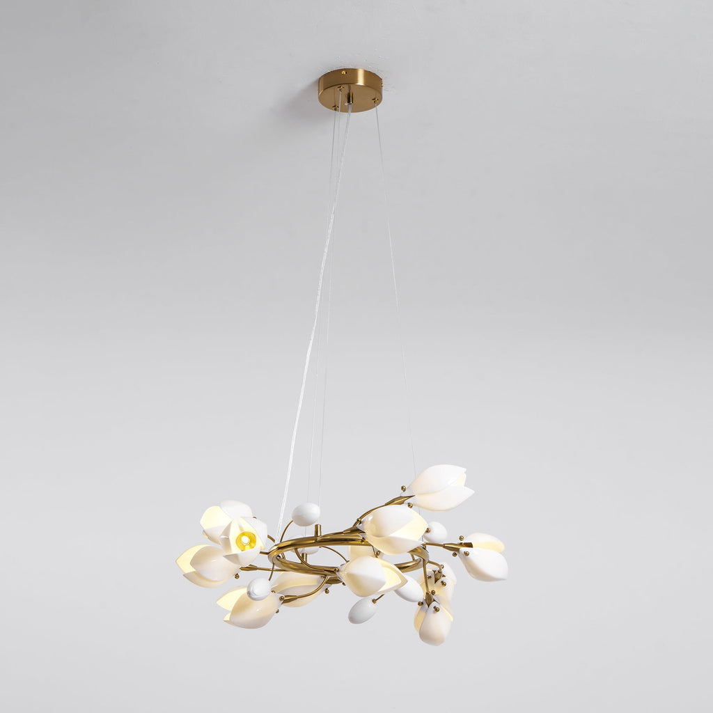 Clérachic ring chandelier hanging from a round gold canopy on fine cables, with one bulb lit among the white petal shades.