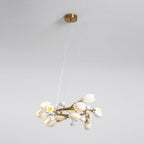 Clérachic ring chandelier hanging from a round gold canopy on fine cables, with one bulb lit among the white petal shades.